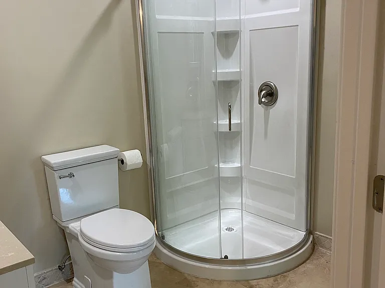 Travertine Floors , all new Shower stool and toilet