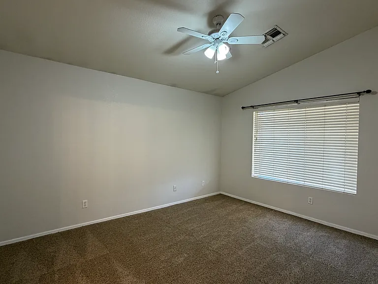 Primary Bedroom has new carpet, ceiling fan & vaulted ceiling