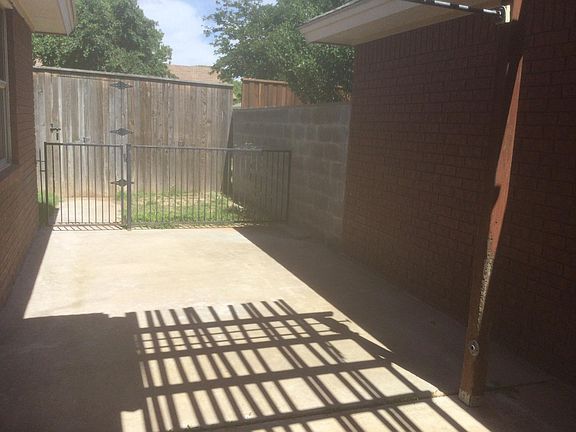 Back yard with additional fencing off side patio