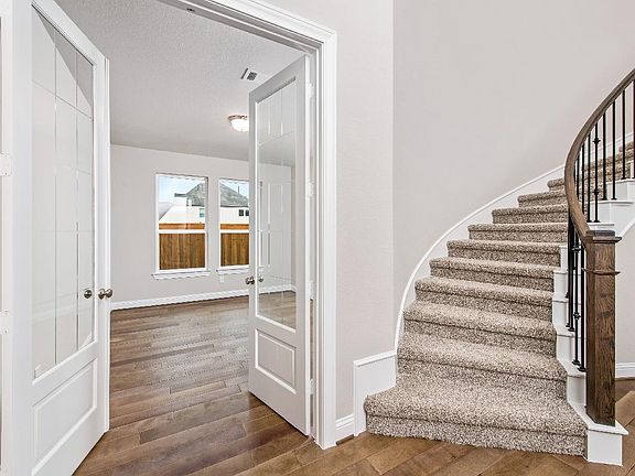 Curved staircase and study with french doors