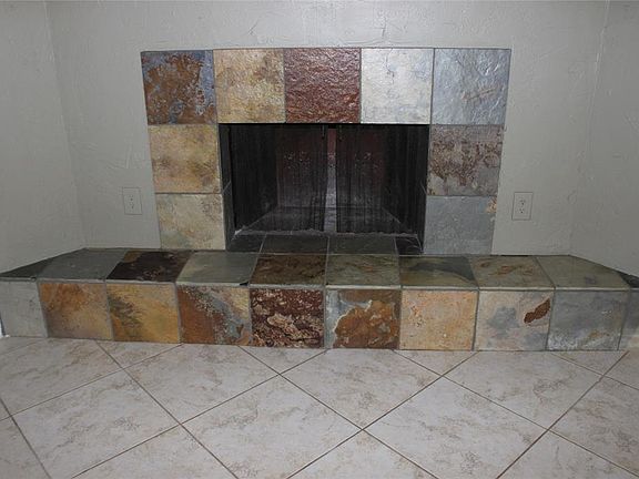 Additional view of your tiled woodburning fireplace.