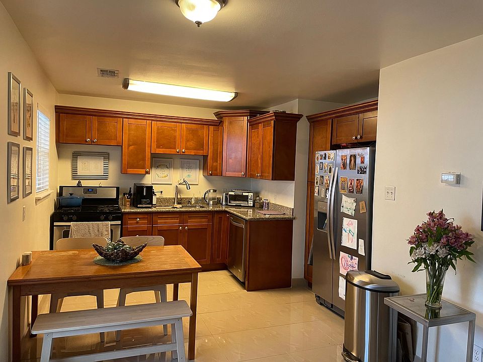 Kitchen features stainless steel appliances including a dishwasher, nice wood cabinets and granite counters.