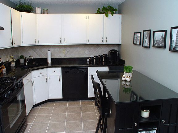 Eat-in kitchen with newer appliances, granite counters and ceramic tile floors