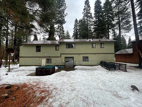 Backyard view w/snow & hot tub