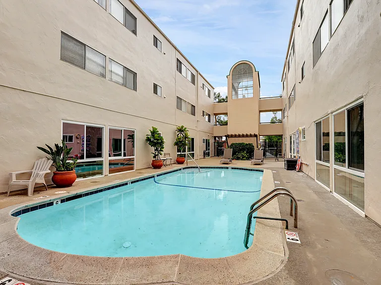 Bask in the coastal air beside our sparkling blue pool, a peaceful oasis for sunshine and connection.