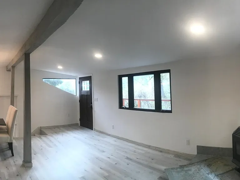Front door living room, dining area & modern gourmet kitchen with large windows overlooking the Santa Cruz mountains. Large wood stove for additional heating.