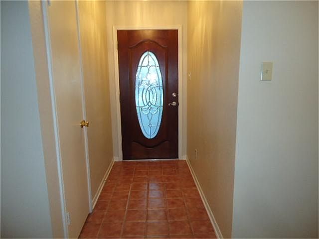 Foyer with tile floors and gorgeous glass and wood front door