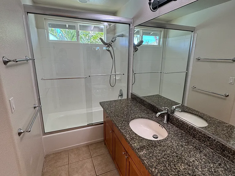 Master bedroom bathroom. New Shower doors, shower head, and sink faucet.