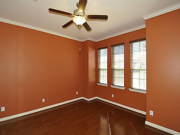 This study is just off the foyer with a French door for privacy. The window treatments are wood blinds. The flooring is a 5" Pecan. This is real wood.Nice crown molding.