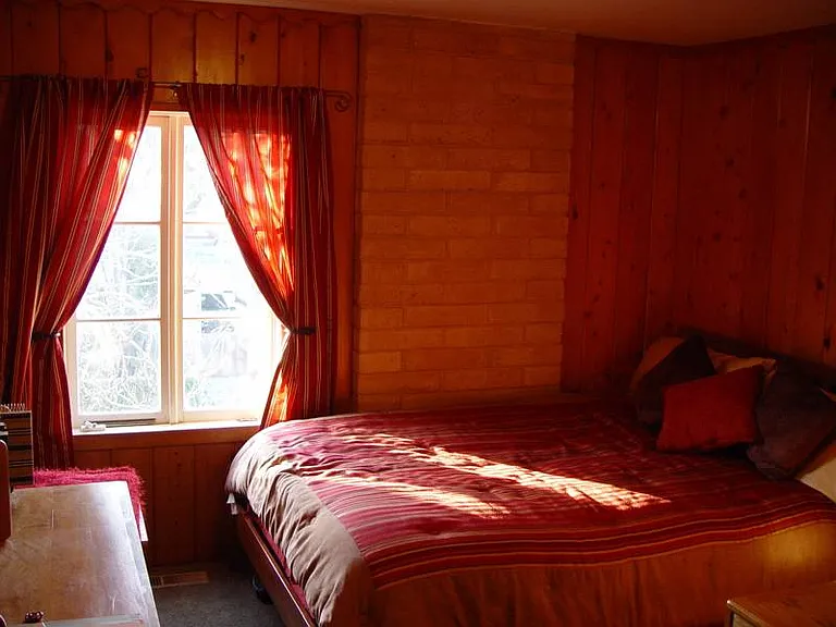 Hallway bedroom. Queen bed and a set of bunk beds.