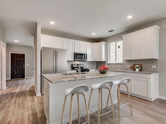 Entry into spacious kitchen with eat-in island