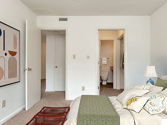 Experience the tranquility of this cozy bedroom with ensuite bathroom and contemporary decor.