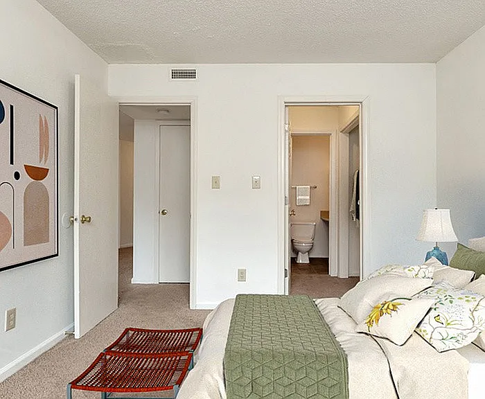 Experience the tranquility of this cozy bedroom with ensuite bathroom and contemporary decor.