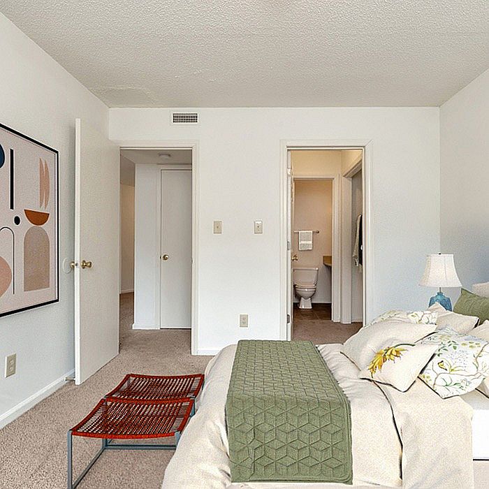 Experience the tranquility of this cozy bedroom with ensuite bathroom and contemporary decor.