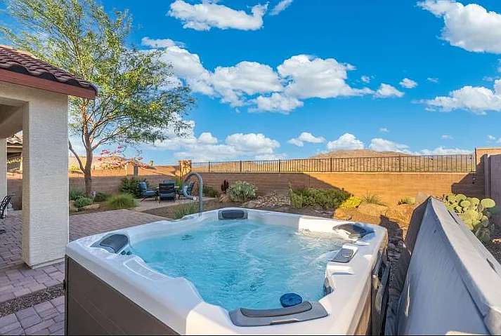 An open-air retreat surrounded by scenic mountain landscapes dipping in the hot tub.