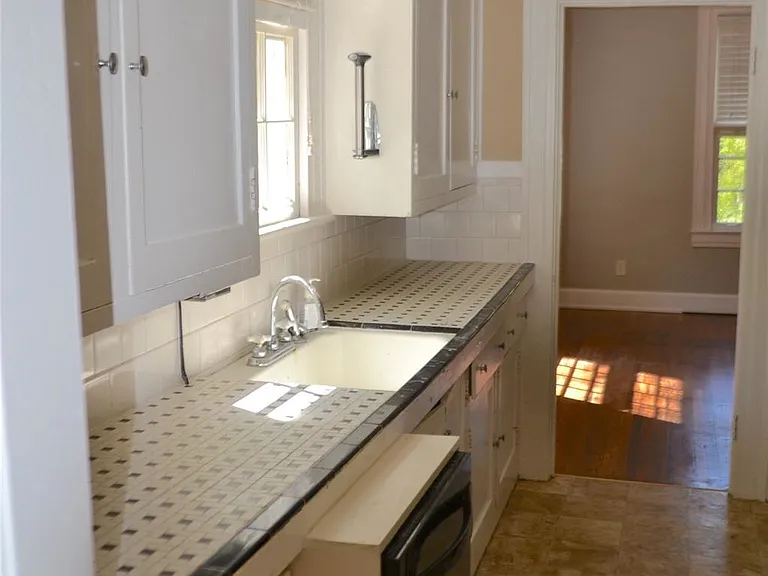 kitchen (original counters are more narrow than contemporary and when a long-time renter wanted a dishwasher, it was installed with a frame around it)