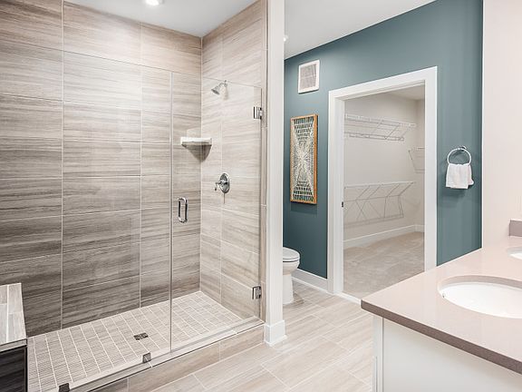 Luxurious Owner s Bath featuring a Frameless Shower and a Double Bowl Sink