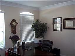 A study with a glass door is located off of the foyer.