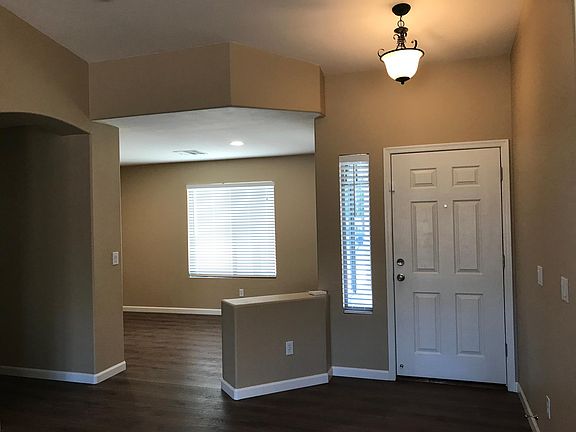 Front entrance with the open den which has 2 large windows.