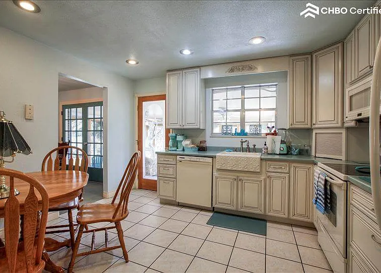 Kitchen connects to sun and dining rooms.