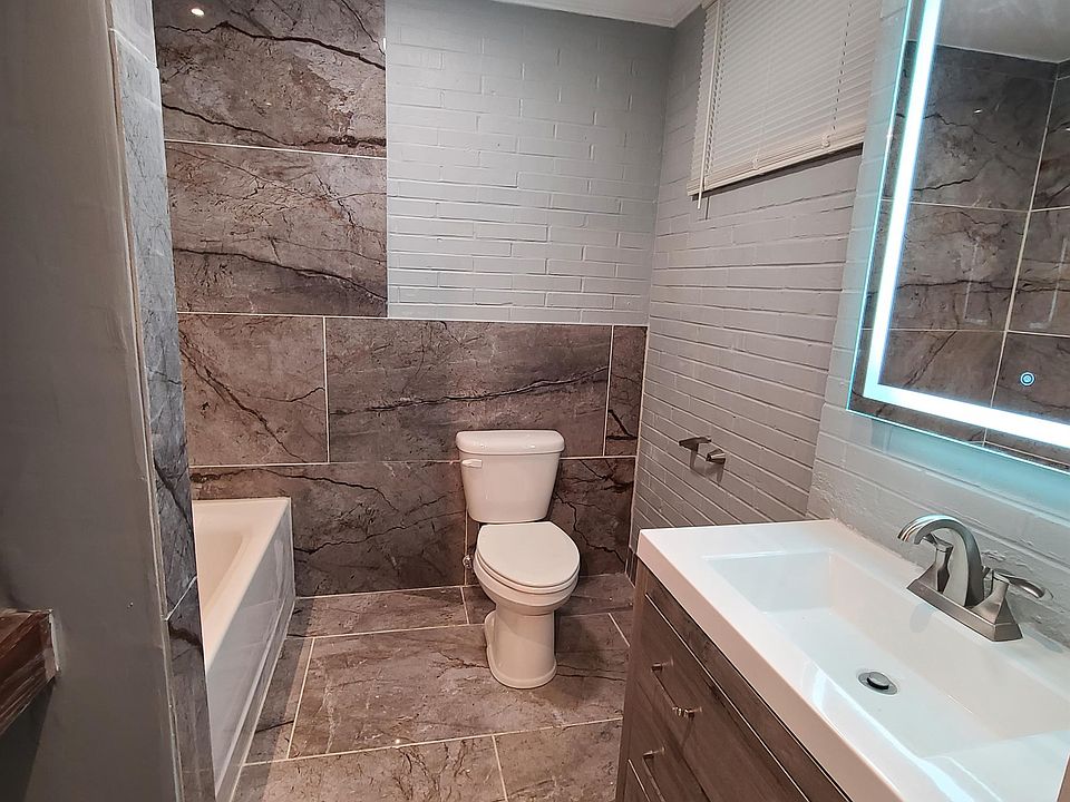 Beautiful bathroom with backlit mirror.