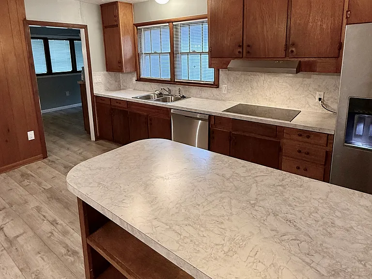 Looking at the kitchen from the dining area and towards the 3rd living area.