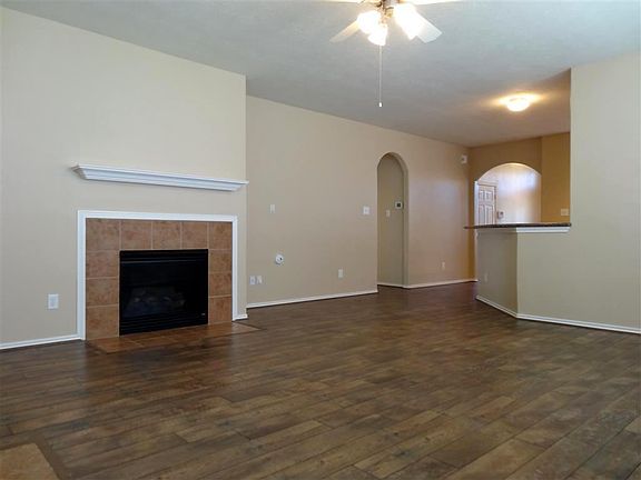 A view of the living room looking towards the entry and kitchen.