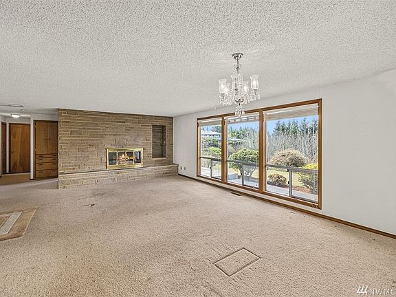 A view from the Dining Area towards the floor to ceiling Wood Burning Fireplace. 