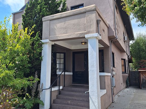 Front of duplex with driveway for the unit with two-car parking and bicycle storage space.