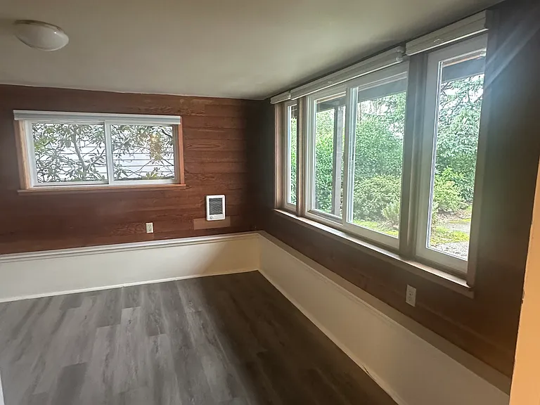 Front bedroom with abundant natural light. A favorite choice for a home office, with views of the private patio.