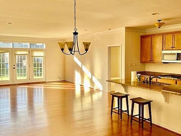 Open concept first level with doors leading out to back patio