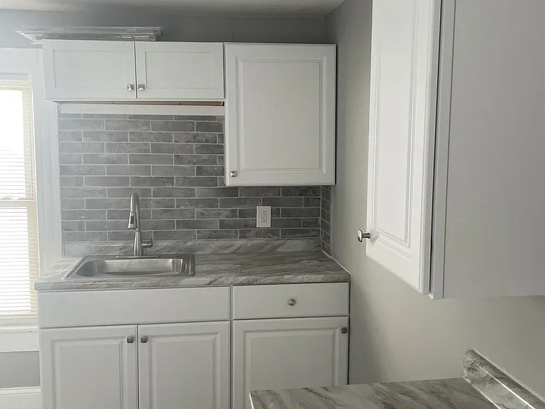 All new kitchen with vinyl flooring, new cabinets and new sink