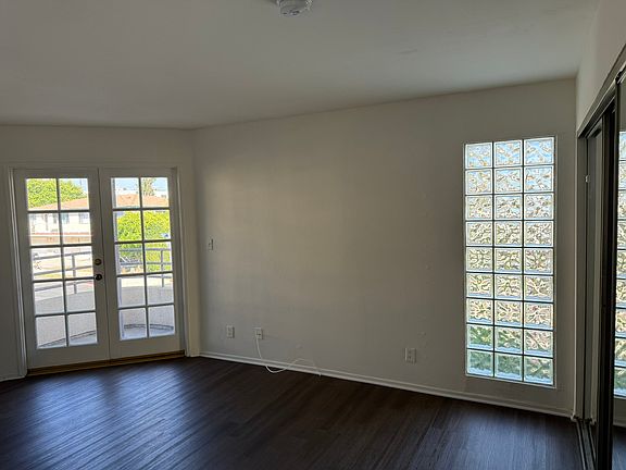 Primary bedroom with french doors opening to private balcony