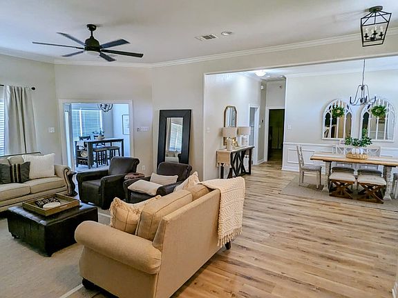 View of the living and dining room taken from the hallway of the two additional bedrooms.