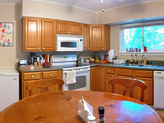 Kitchen includes stove with convection microwave, dishwasher, and refrigerator. There is washer drier connections in adjoining laundry room.