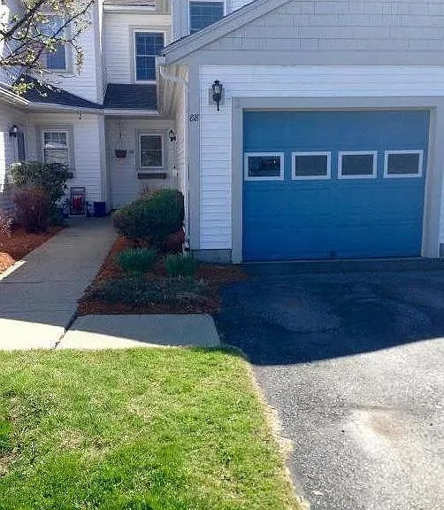 Attached garage with shelving for storage.