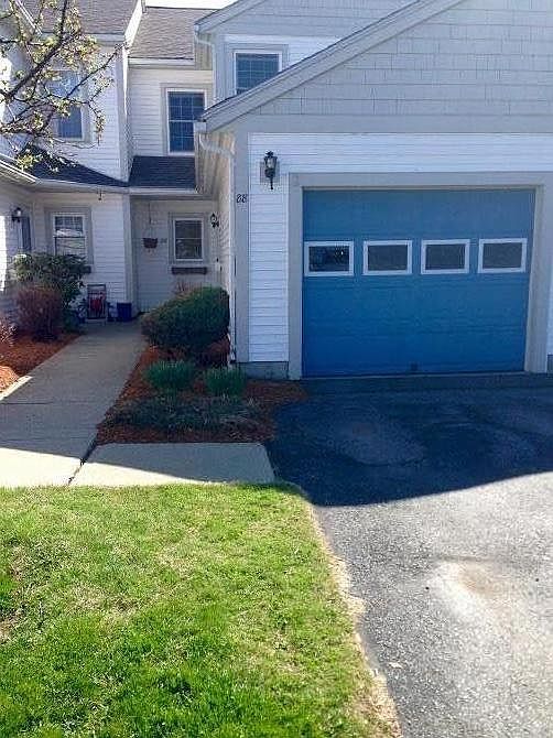 Attached garage with shelving for storage.