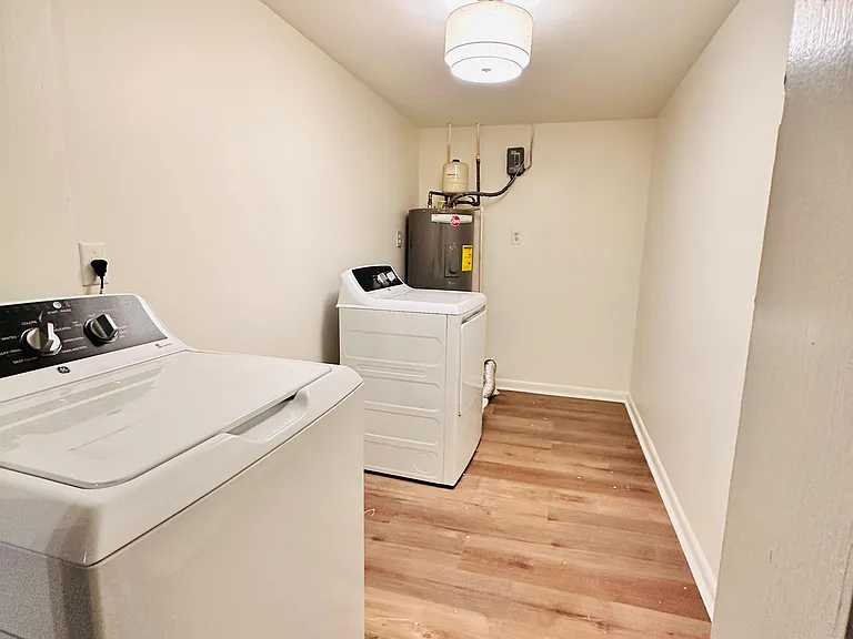 Dedicated laundry room with washer/dryer hookups and easy-clean flooring, offering convenient in-home laundry access.