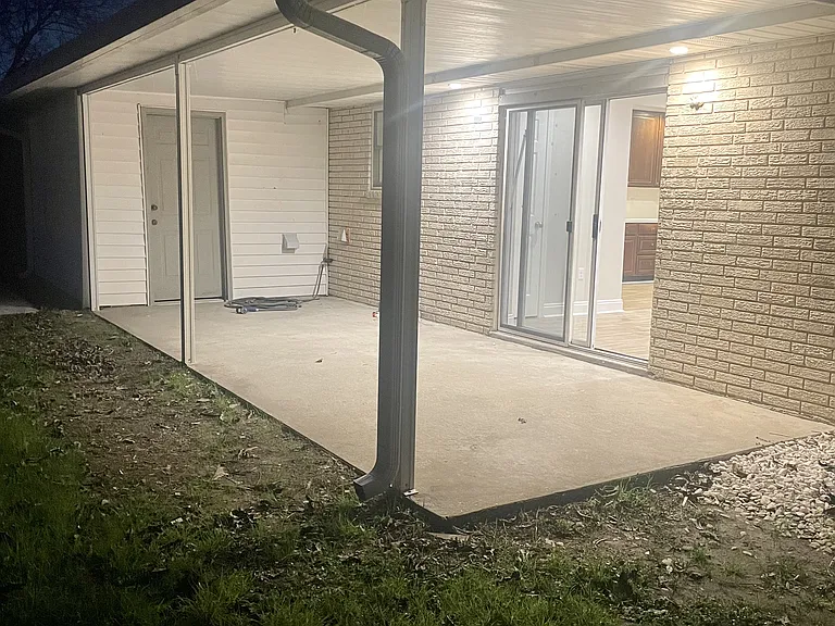 Covered patio in the private backyard, ideal for outdoor entertaining and relaxation.