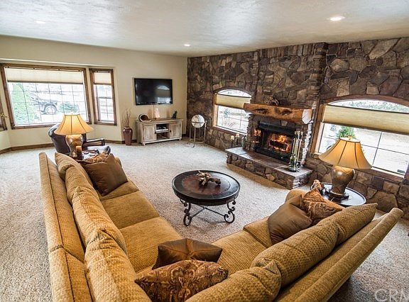 Over 800 sf in this great room. Cozy wood fireplace, a ton of natural light, dual stairway leading up to loft and a sliding glass door leading out to the back yard.