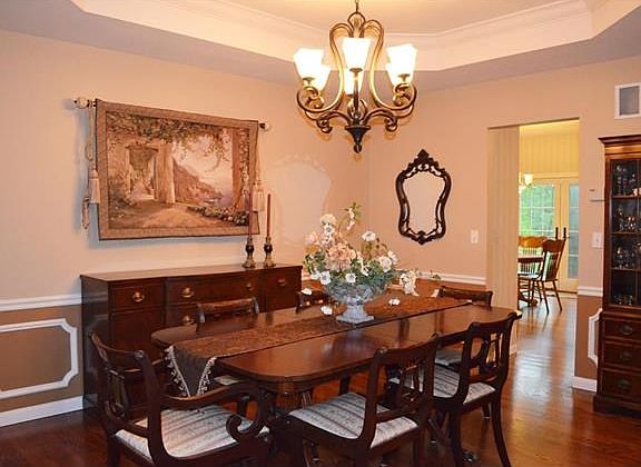 Exquisite large Dining Room with coffered ceiling, custom trim and hardwood floors!