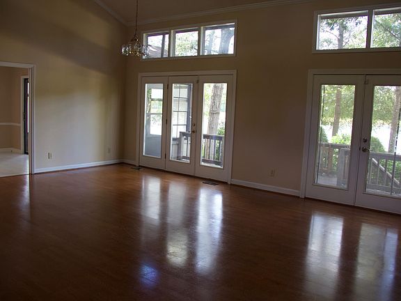 Large great room with lots of windows overlooking water