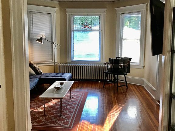 Looking living room from dining room - beautiful vintage stain glass window