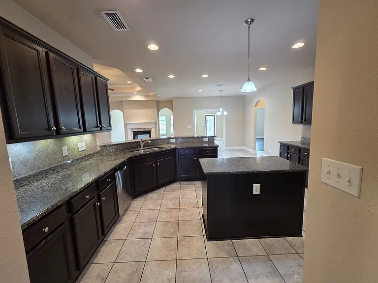 Kitchen facing breakfast nook and sunroom