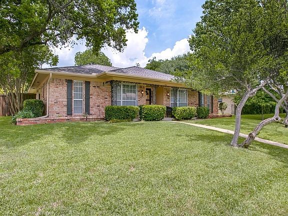Gorgeous lush grass compliments this large corner lot.