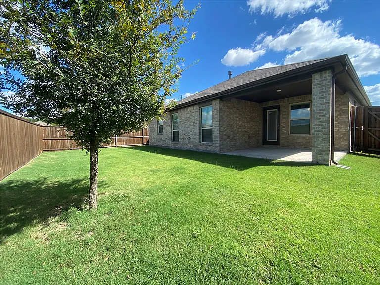 This stunning, modern brick residence showcases sophisticated architectural lines and a refined aesthetic. The property boasts an expansive backyard area that offers both privacy and space, perfect for outdoor living. Highlights of the rear grounds includ