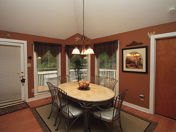 The dining room has access to the deck and plenty of windows offer views.