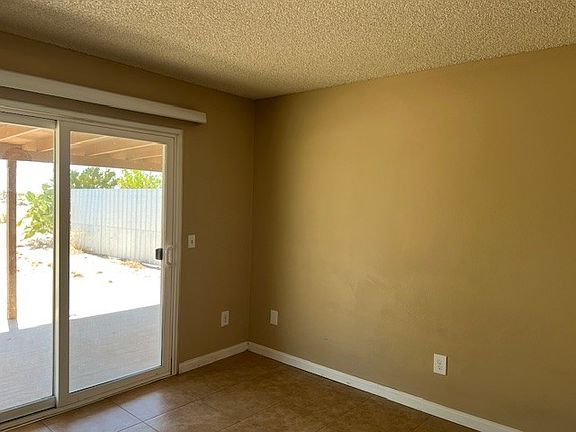 Bedroom with slider to backyard