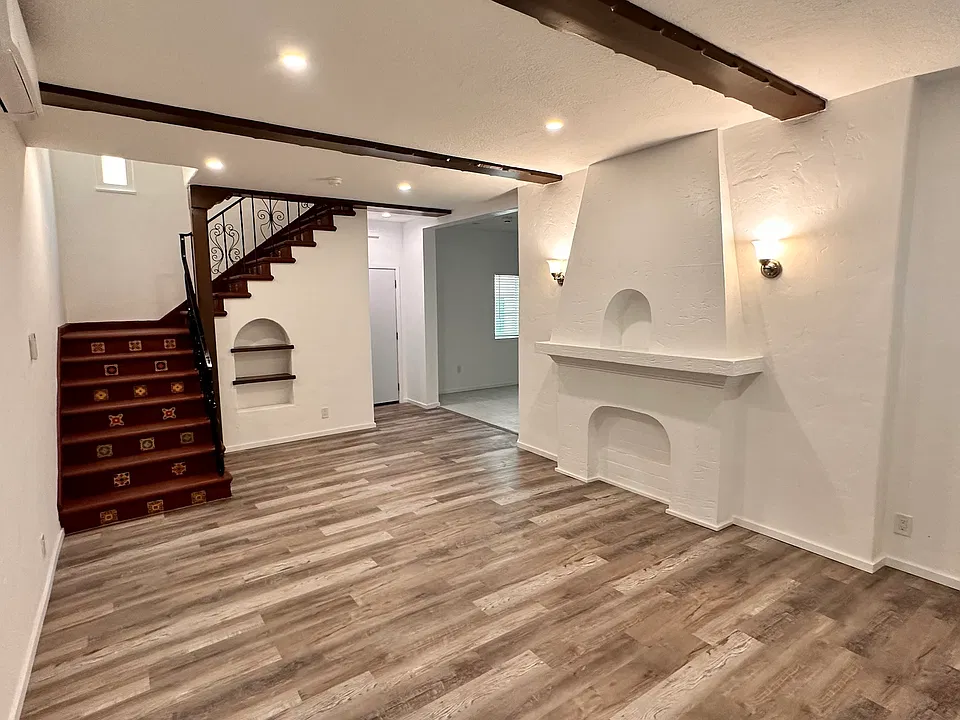 Living room with recessed lights and stairwell