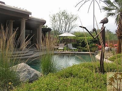 Absolute serenity and privacy in the large yard area with pool and spa. Grass side yard and lush desert landscaping create the perfect setting. Retractable awnings for shade.